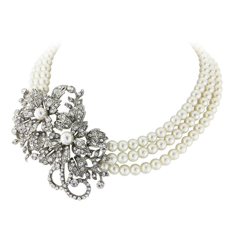 Pearl necklace made with rows of ivory faux pearls and a crystal motif, motif measures 9cm by 5.5cm.
