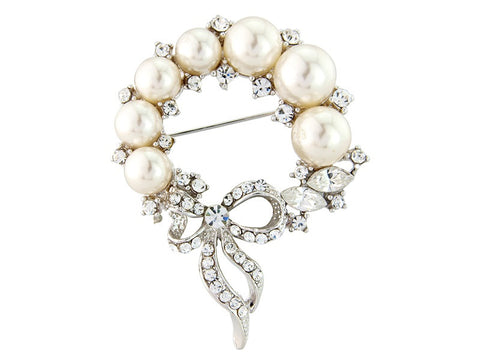 Crystal and pearl brooch in a rosette design with bow detail, made from high quality crystals and pearls on a rhodium silver finish.