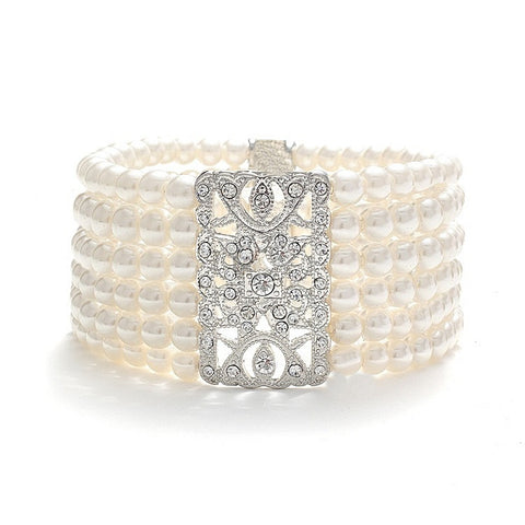 Elasticated pearl bracelet with six rows of simulated ivory pearls and a unique crystal embellishment, bracelet measures 4cm. 