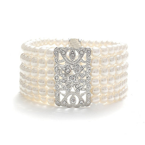 Elasticated pearl bracelet with six rows of simulated ivory pearls and a unique crystal embellishment, bracelet measures 4cm.