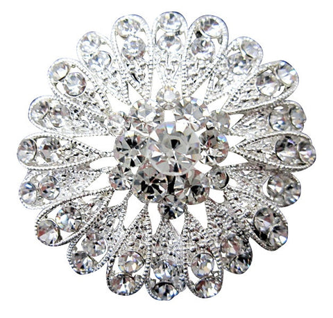 Intricate brooch with clear crystals on a silver tone finish, brooch measures 5cm by 5cm.