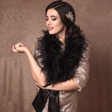 Front view of bride wearing a black ostrich feather stole wrap tied with ribbon