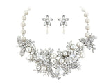 Crystal and pearl necklace set made from ivory pearls and clear cubic zirconia crystals on a silver tone finish. 