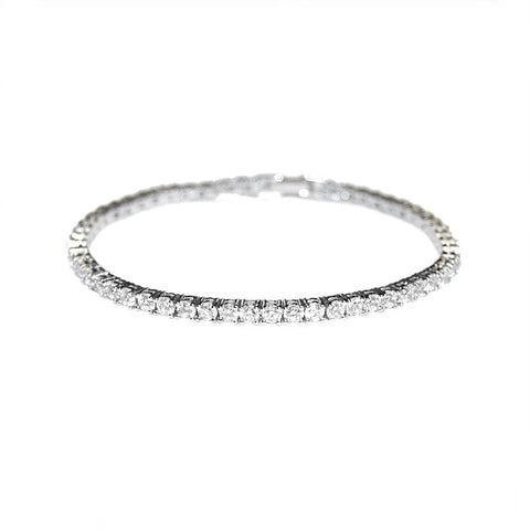 Petite and chic crystal bracelet made with clear cubic zirconia crystals on a silver tone rhodium plated finish. 