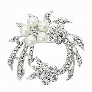 Crystal and pearl brooch in a floral design inlaid with clear crystals on a rhodium plated finish, complimented by ivory pearls, brooch measures 5cm by 4.5cm